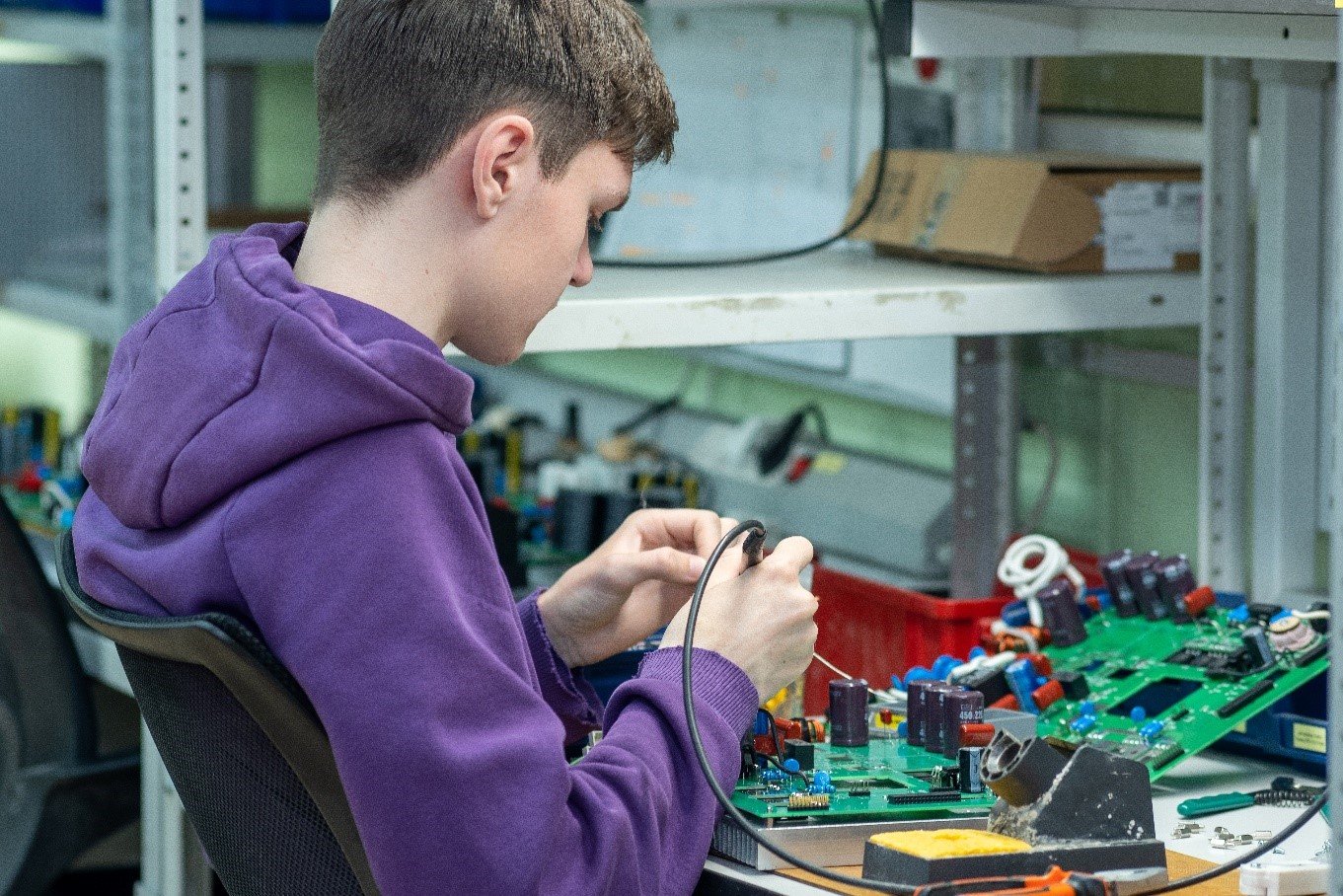 Youngman learning to solder.